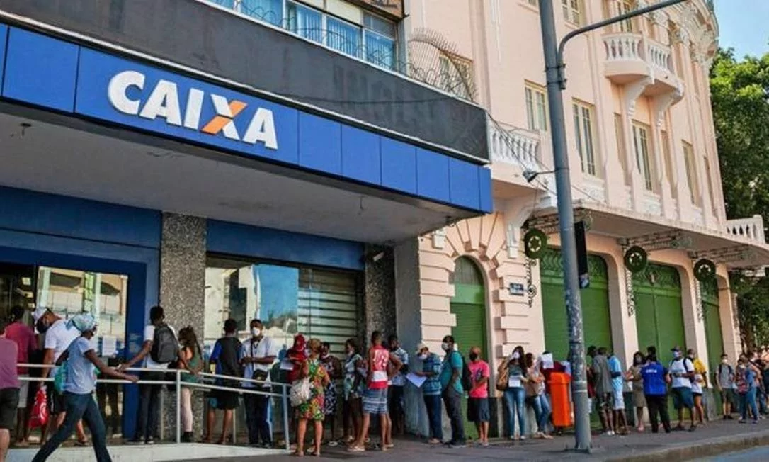 People waiting in line to receive financial aid from Brazilian government. People waiting in front of an office of federal banking Caixa Econômica Federal to receive the financial aid.